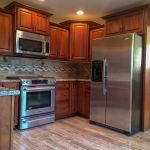 Hand crafted wood cabinets and backsplash in newly remodeled home in Lincoln, NE
